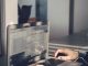 A person typing on a laptop inside an office, emphasizing technology and productivity.